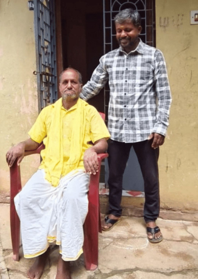 Two men outside a house