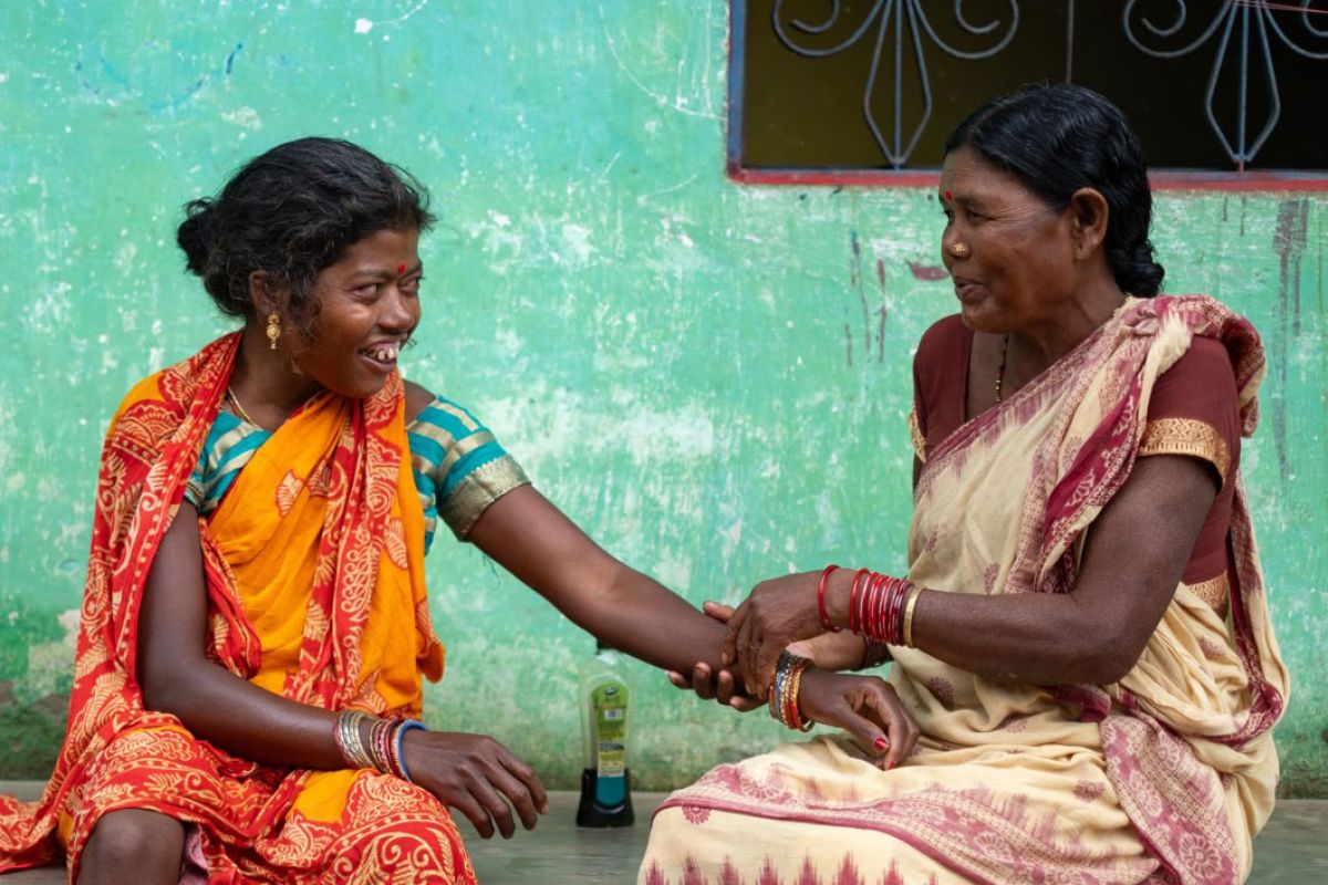 two carers hold hands