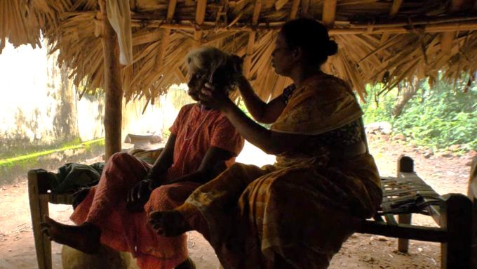 A woman brushing her mother's hair.