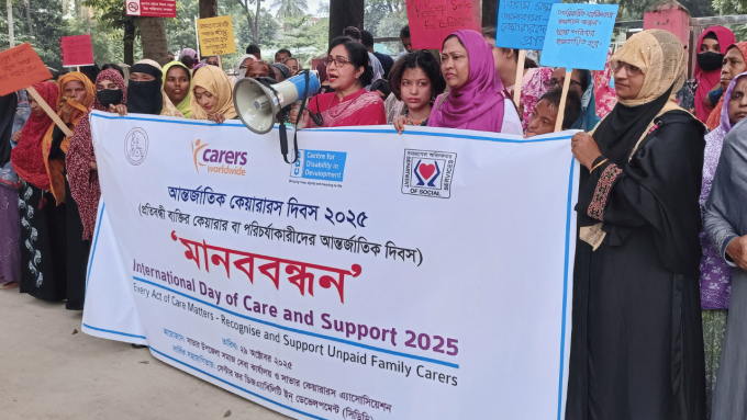 Group of people standing behind a large banner