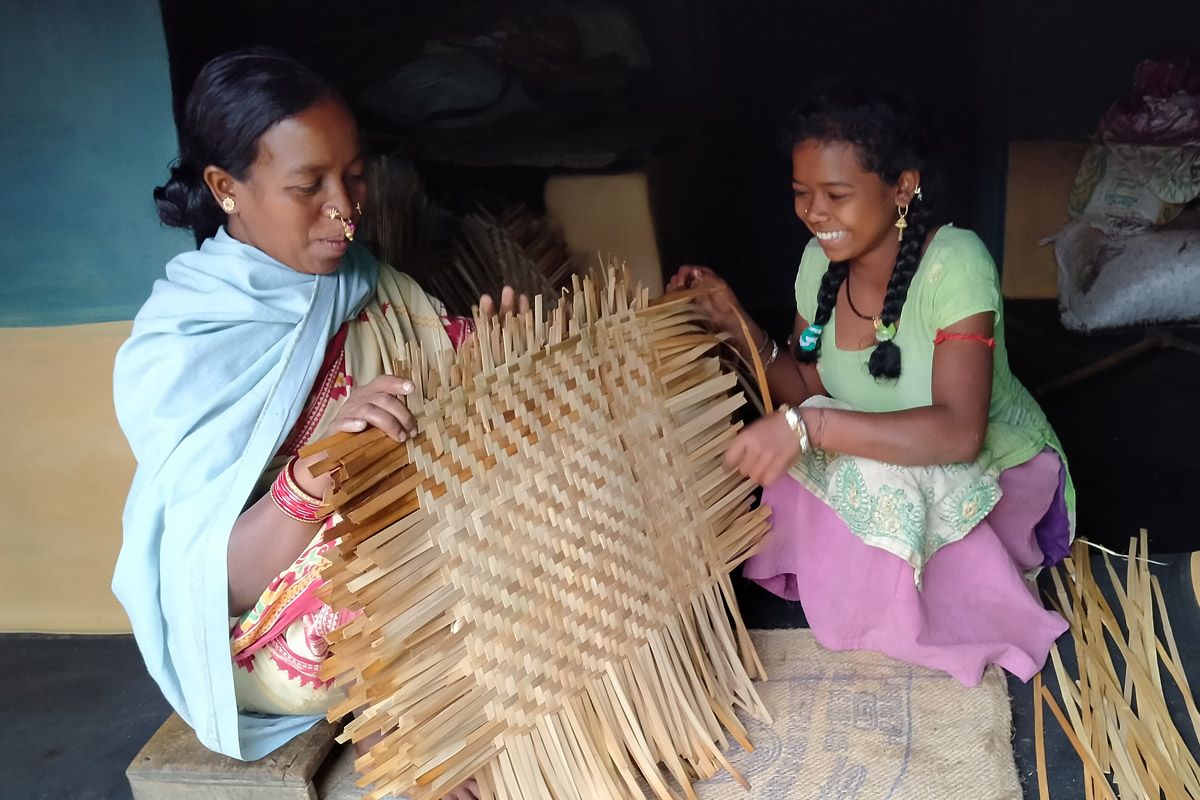 two women weaving